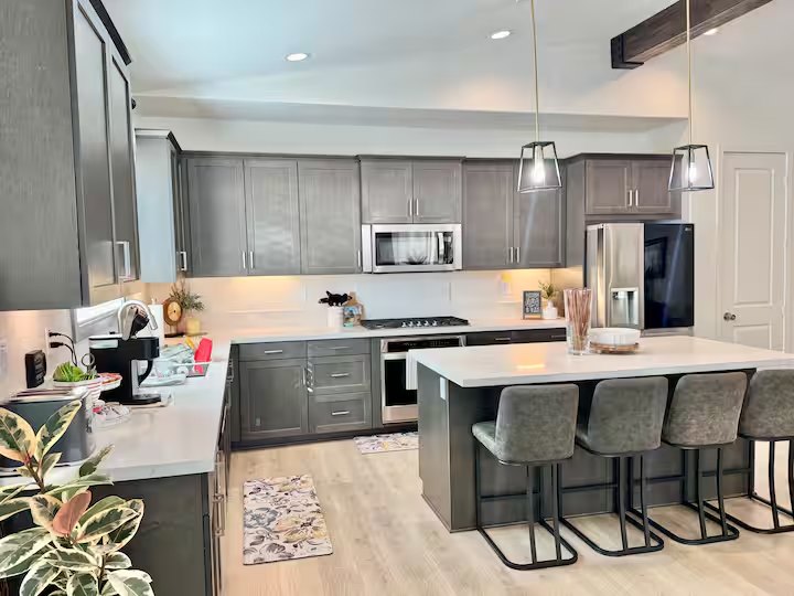 The shared Landon House kitchen with refrigerator, microwave, stove, and island